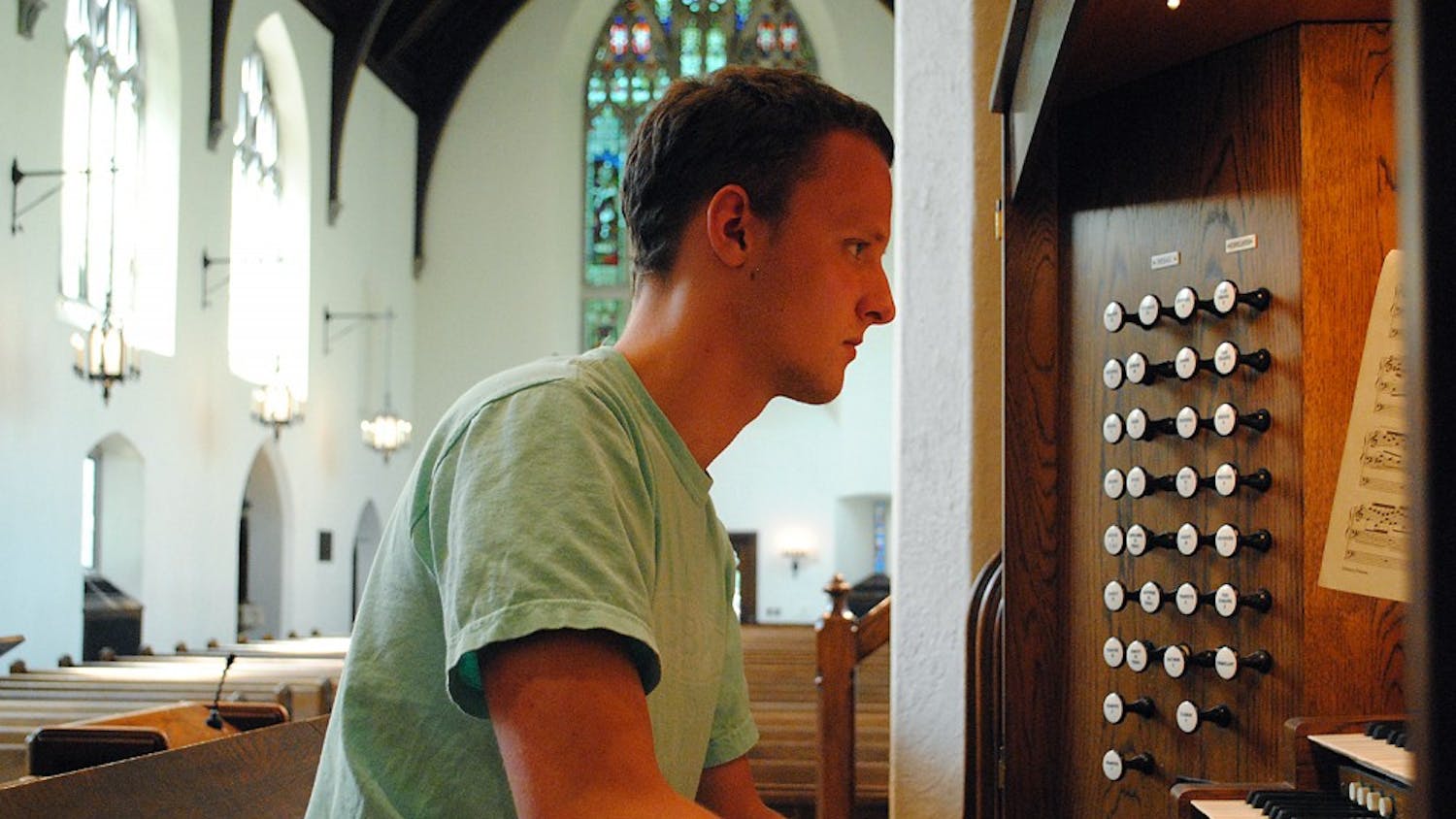 Senior Eric J. Surber practices playing the organ at Chapel of the Cross, where he has been performing at various services for three years. 