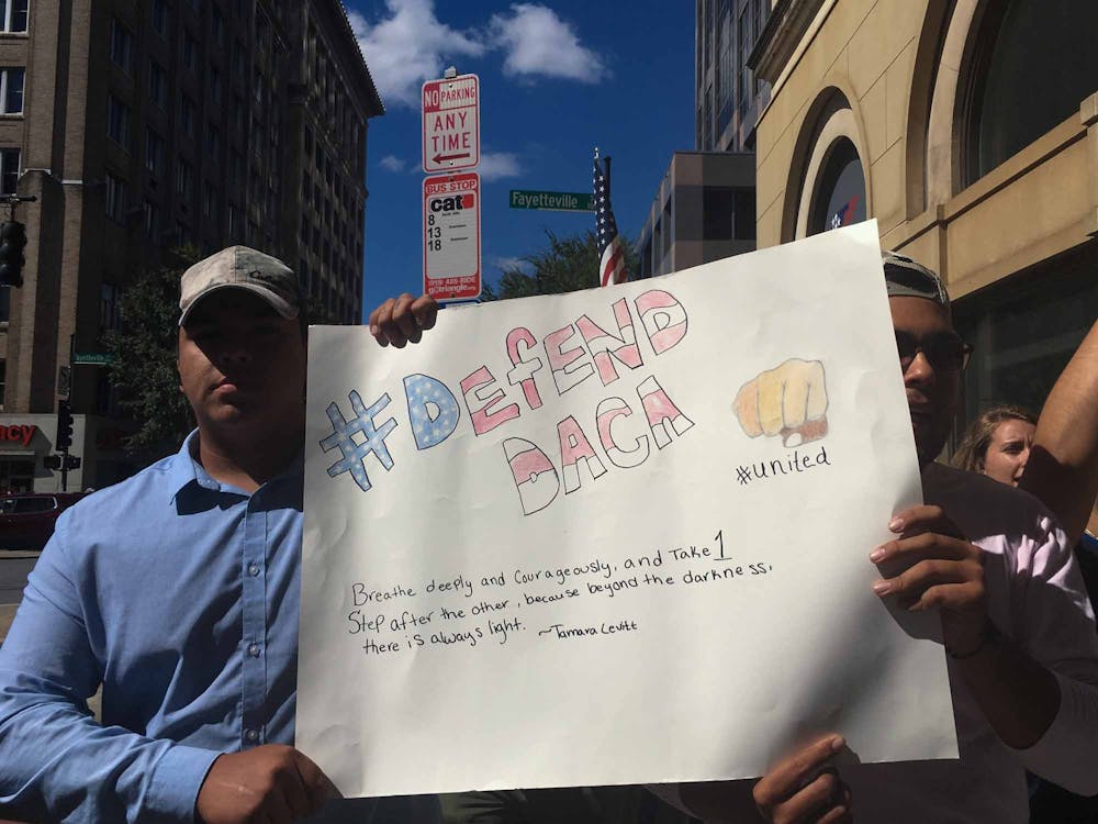 <p>Protesters hold a sign during a demonstration in downtown Raleigh on Sunday, Oct. 1, 2017. About 250 people participated in the protest in support of DACA after President Donald Trump announced that he would phase out the program.</p>