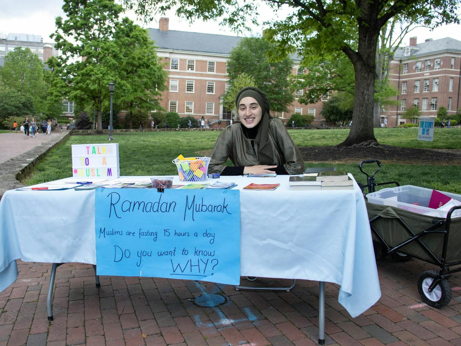 UNC senior Rida Bayraktar sits at Polk Place on Friday, April 14, 2023. Bayraktar is the most recent vice president of the UNC Muslim Students Association which sets up a table every Friday and reaches out to other clubs on campus, in order to bring more people into the community and celebrate holidays, such as Ramadan, together.