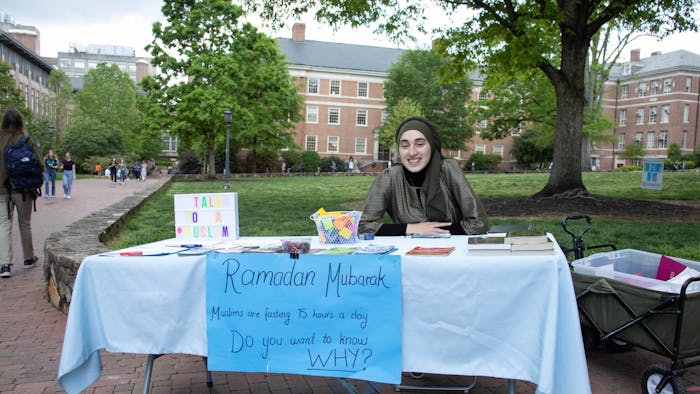 UNC senior Rida Bayraktar sits at Polk Place on Friday, April 14, 2023. Bayraktar is the most recent vice president of the UNC Muslim Students Association which sets up a table every Friday and reaches out to other clubs on campus, in order to bring more people into the community and celebrate holidays, such as Ramadan, together.