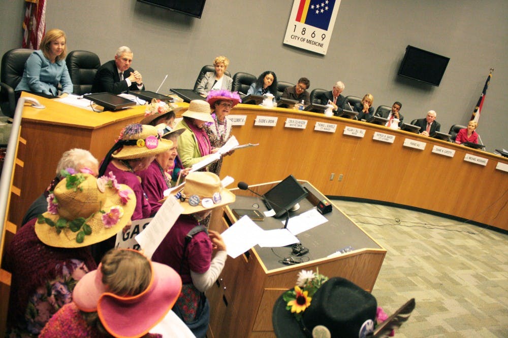 The Raging Grannies walk to the podium to sing for the Utilities Commission. The public was allowed to talk about how they felt about Duke Energy's tax hike during the meeting. 