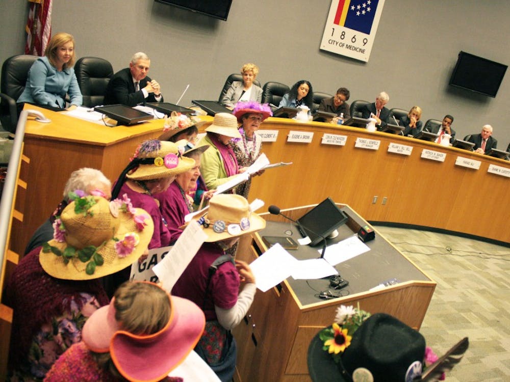 The Raging Grannies walk to the podium to sing for the Utilities Commission. The public was allowed to talk about how they felt about Duke Energy's tax hike during the meeting. 