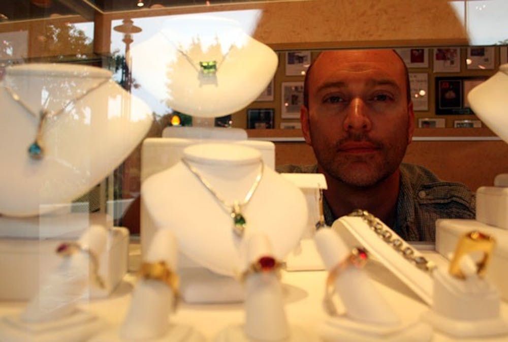 Award-winning jeweler William Travis Kukovich looks at his creations. DTH/Ryan Jones