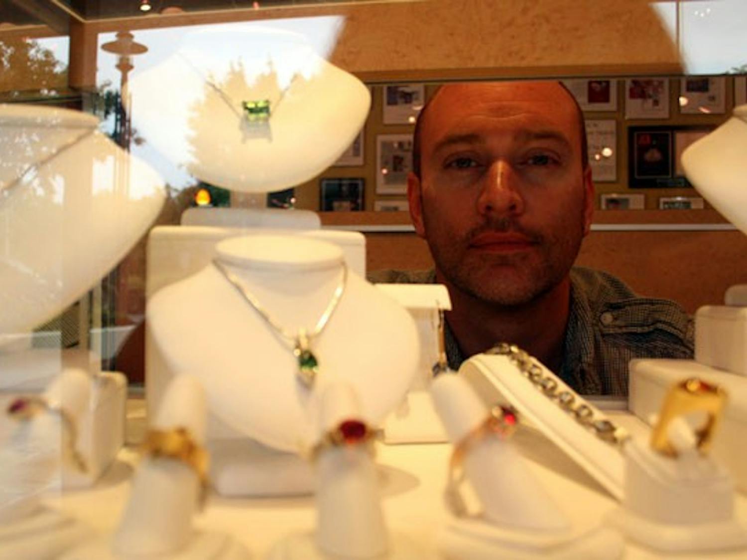 Award-winning jeweler William Travis Kukovich looks at his creations. DTH/Ryan Jones