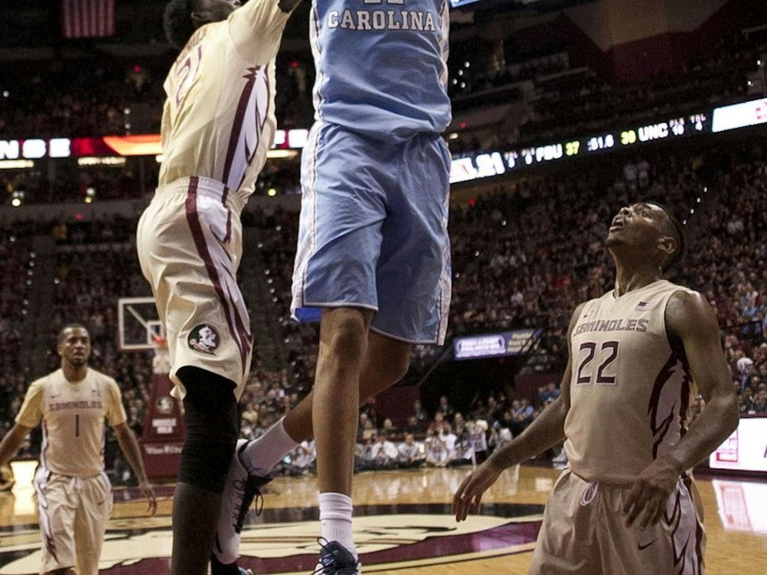 North Carolina's Brice Johnson (11) dunks for two of his career high 39 points over Florida State's Chris Koumadje (21) and Xavier Rathan-Mayes (22) on Monday, Jan. 4, 2016, at the Tucker Center in Tallahassee, Fla. (Robert Willett/Raleigh News & Observer/TNS)