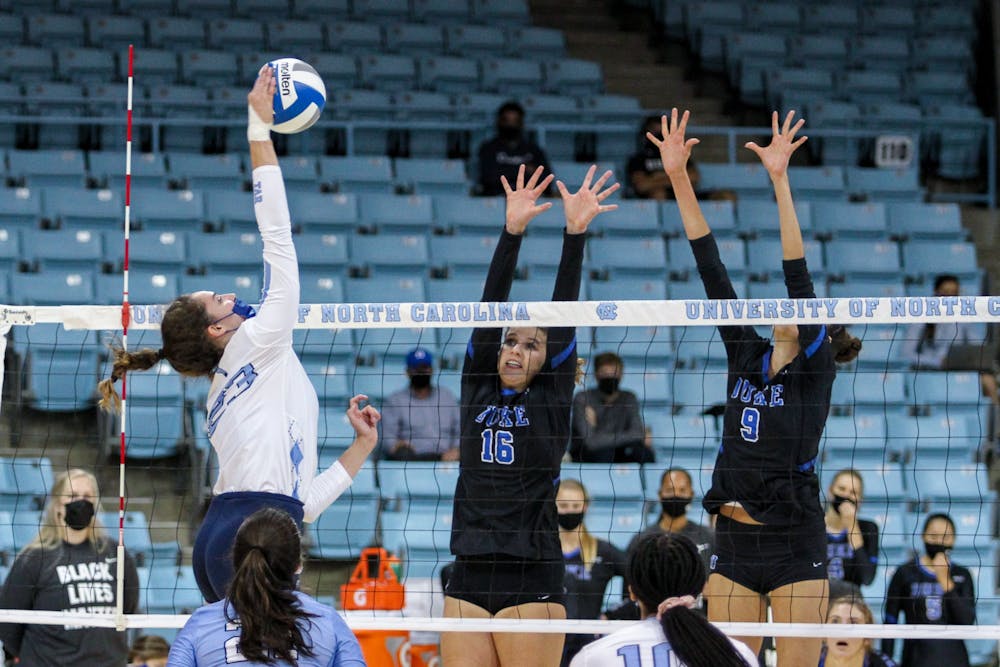 UNC sophomore outside hitter Parker Austin (23) spikes the ball in Carmichael Arena on Oct. 9, 2020. The Tar Heels beat the Blue Devils 3-1.