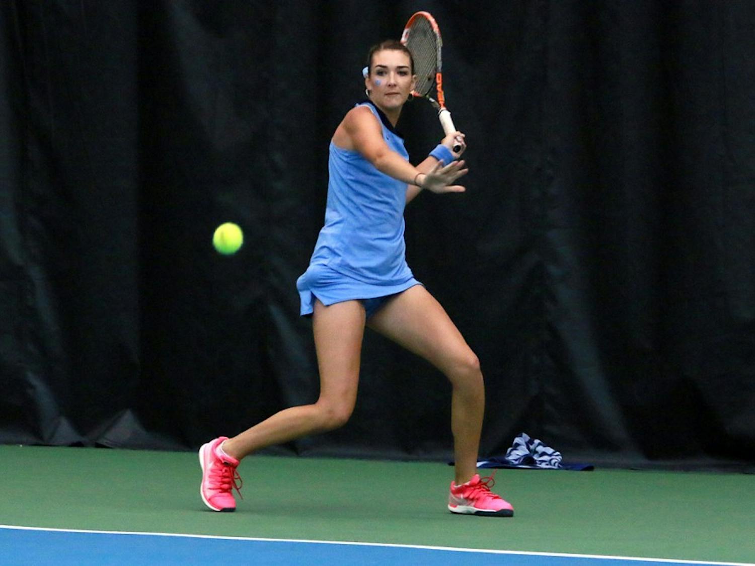 Carolina Price, the only senior on the women's tennis team, returns the ball. Price defeated Samantha Harris during the singles competition.