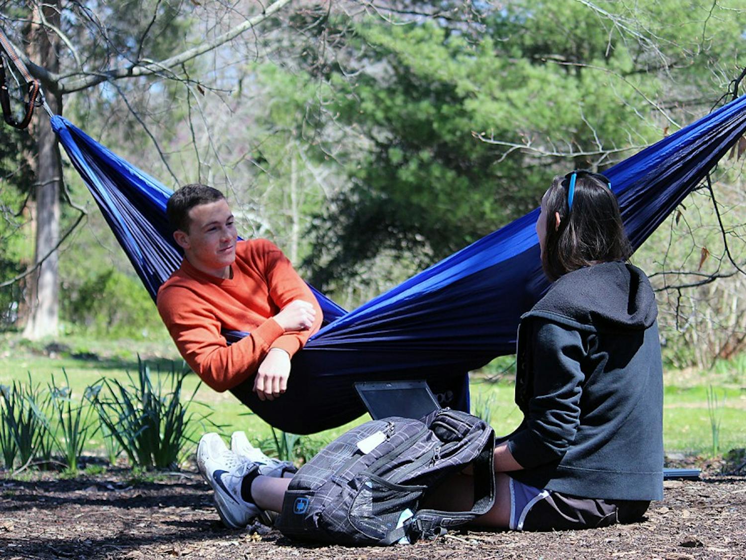 Patrick O'Neill, a sophomore business major, sits in his hammock in the Arboretum on Monday afternoon with Rachel Helms, a junior psychology major. 