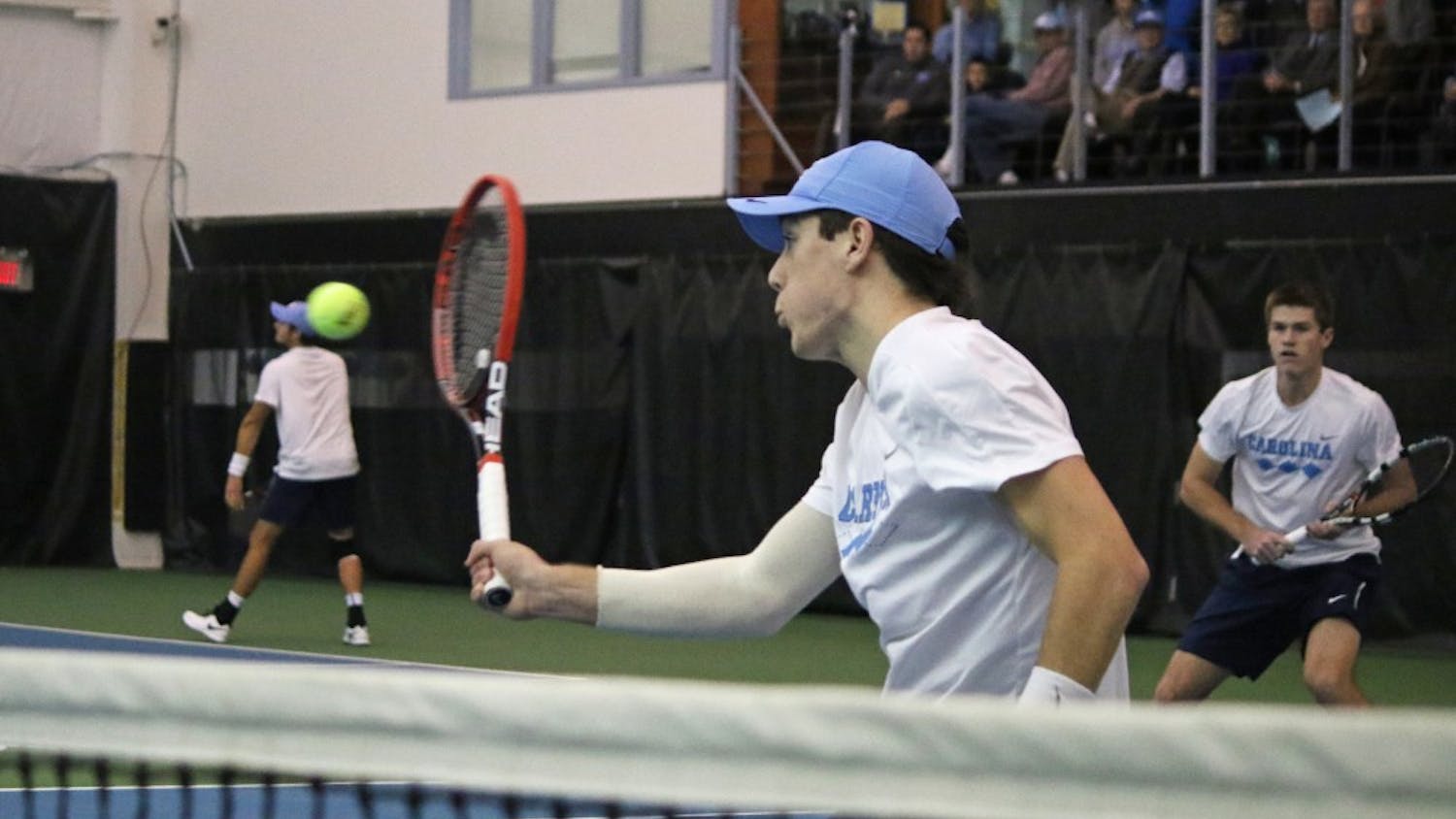 Sophomore Robert Kelly returns a ball while his doubles teammate Brett Clark looks on in No. 7 UNC Men's Tennis team's victory over No.5 Oklahoma 4-3 Sunday afternoon.
