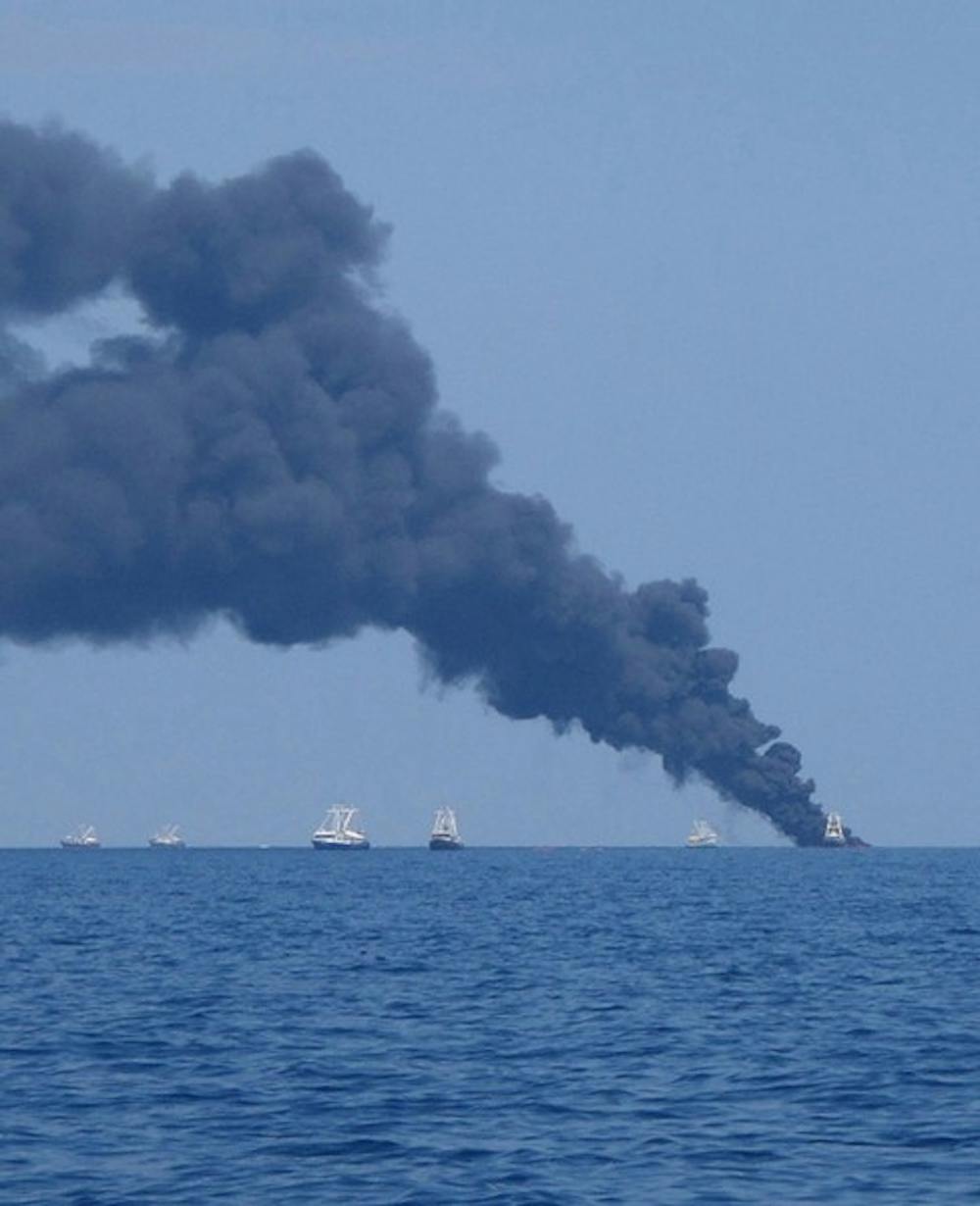 Surface oil from the BP oil spill in the Gulf of Mexico is burned off by teams of relief workers.