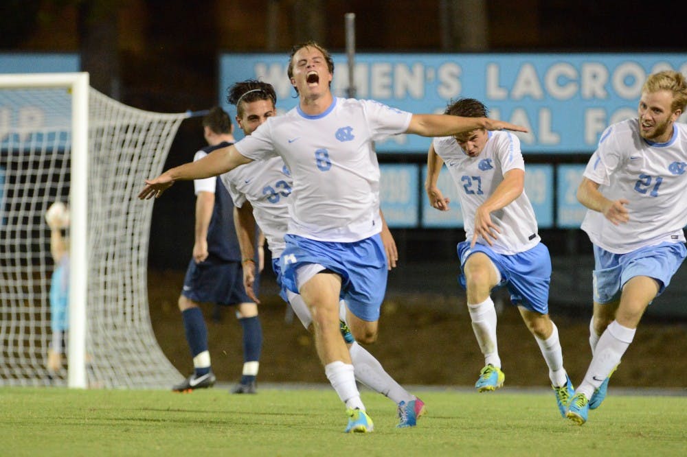UNC forward Tyler Engel (8) celebrates after scoring the game winning goal in the second overtime period.