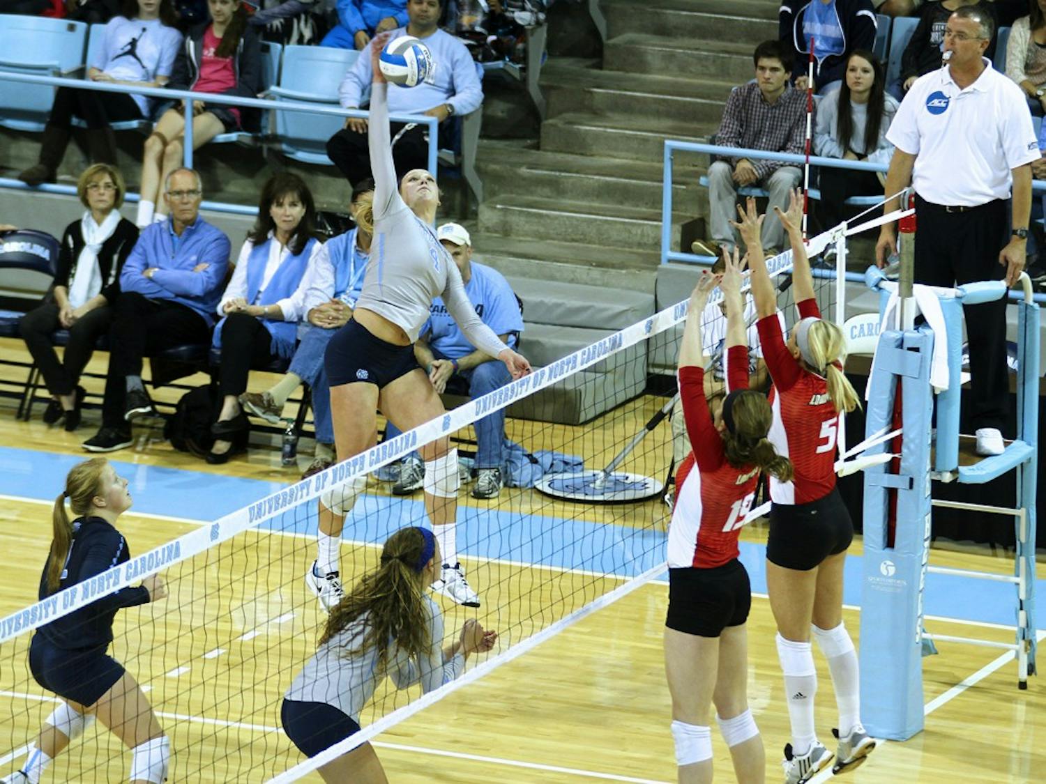 Tar Heel Leigh Andrew (4) taps the ball over the net against Louisville Friday night. 
