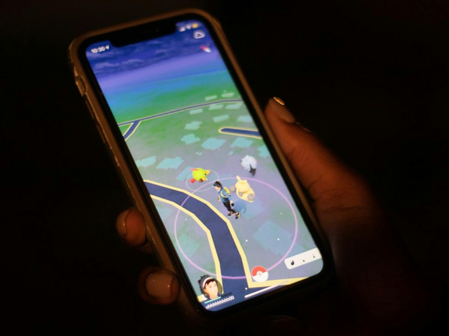 DTH Photo Illustration. A student plays Pokemon Go, a game that became popular in the summer of 2016.&nbsp;
