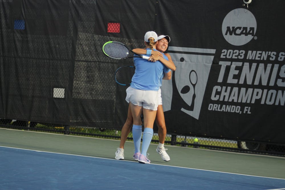 <p>First-year Reese Brantmeier and junior Reilly Tran celebrate after securing the doubles point against N.C. State on Saturday, May 20, 2023. The Tar Heels won, 4-1.</p>
