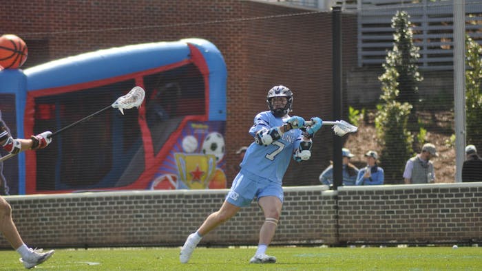 UNC first-year attackman James Matan (7) passes the ball during the men's lacrosse game against Brown at Dorrance Field on Saturday, March 11, 2023. UNC won 19-6.