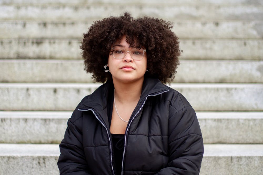 Karly Smith, a senior double majoring in sociology and African, African American, and Diaspora Studies, sits on the steps of Wilson Library on Sunday, Jan. 24, 2021. "Mental health is an important basis for all health," says Smith, who hopes to become a therapist herself. "And it's often overlooked."