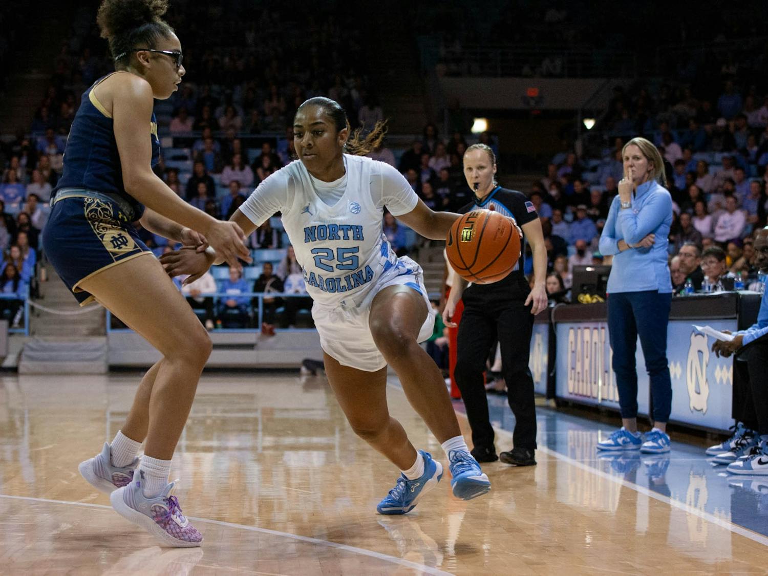 UNC junior guard Deja Kelly (25) looks for a way around her opponent, Notre Dame sophomore guard Olivia Miles (5), to pass the ball during the women's basketball game against Notre Dame on Sunday, Jan. 8 at Carmichael Arena. UNC beat Notre Dame 60-50.