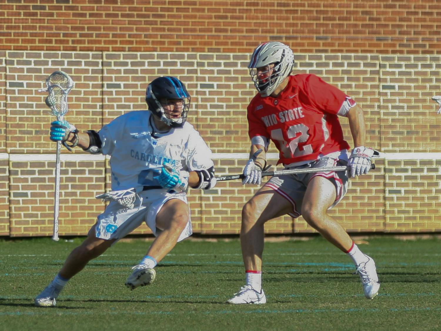 UNC graduate attacker Chris Gray (4) maintains possession during a home men's lacrosse game against Ohio State on Saturday, Feb. 19, 2022. UNC lost 20-8.