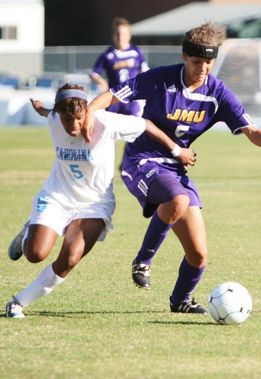 Freshman Crystal Dunn fights off a James Madison defender en route to goal. Dunn scored two goals in North Carolina’s 3-1 victory Sunday.