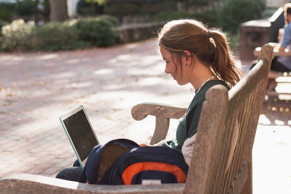 <p>Rosie Robbins, a senior studying religious studies, sits outside on campus on Thursday, Oct. 31, 2019. Robbins is just one of many Carolina students entering the workforce with the looming possibility of a recession.</p>