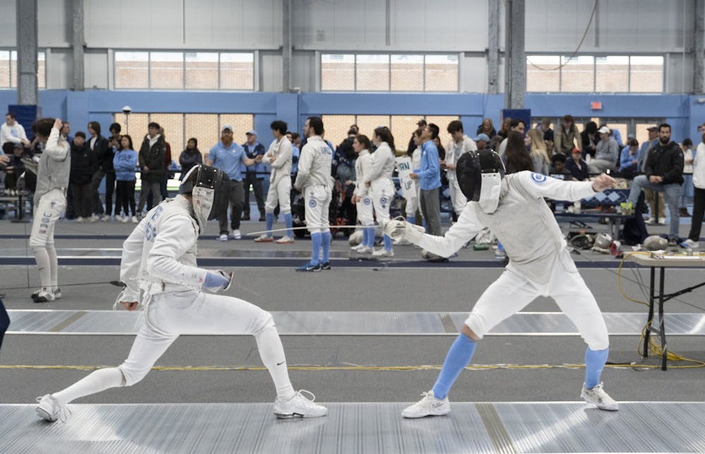 UNC first-year fencer Logan Gatza takes a jab at his opponent during the Tar Heel Invitational against Long Island University and the Air Force Academy on Sunday, Feb. 12, 2023, held at Eddie Smith Field.