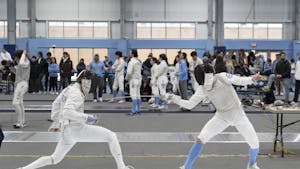 UNC first-year fencer Logan Gatza takes a jab at his opponent during the Tar Heel Invitational against Long Island University and the Air Force Academy on Sunday, Feb. 12, 2023, held at Eddie Smith Field.