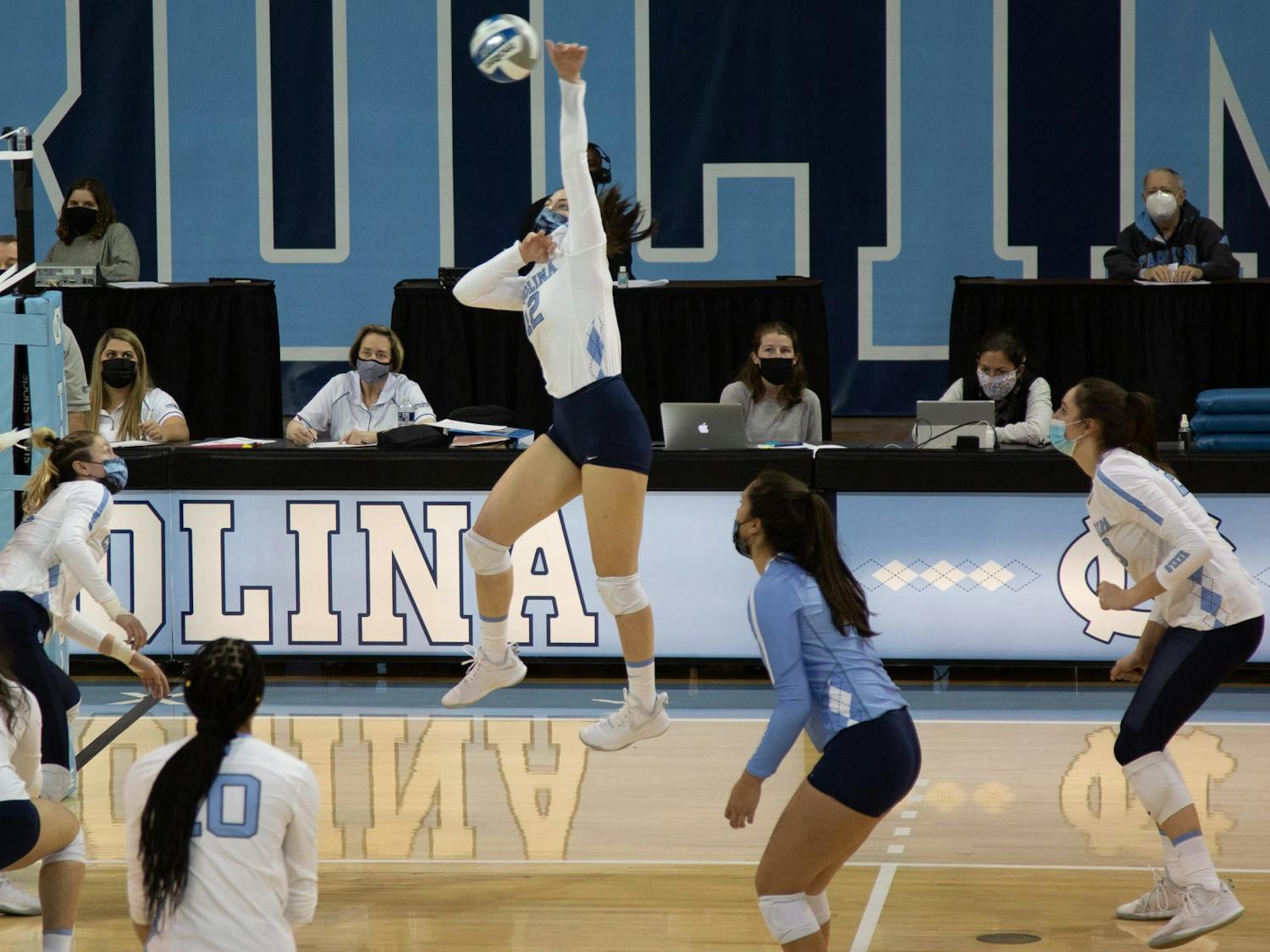 Junior setter Erin Boone (12) hits the ball in a volleyball game against Appalachian State University on Thursday, Feb. 18, 2021 in Carmichael Arena. The Tar Heels won 3-0.
