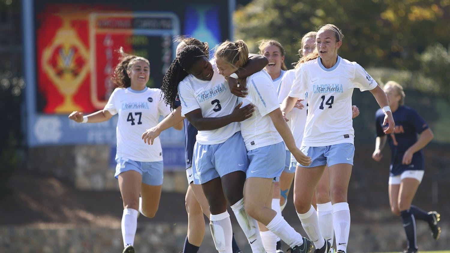 The women's soccer team celebrates after Madison Schultz (1) scored against Virginia on Sunday. 