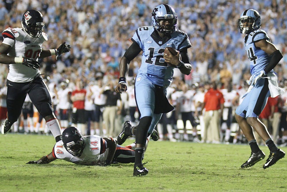 Marquise Williams beats a Liberty Defender to score his second touchdown. Williams started the game, throwing for 169 yards and rushing for 52.