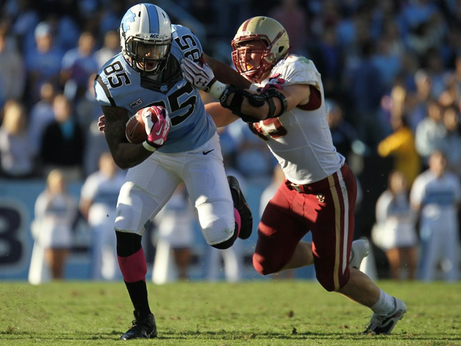 Former UNC tight end Eric Ebron attempts to shake off a Boston College defender in 2013.