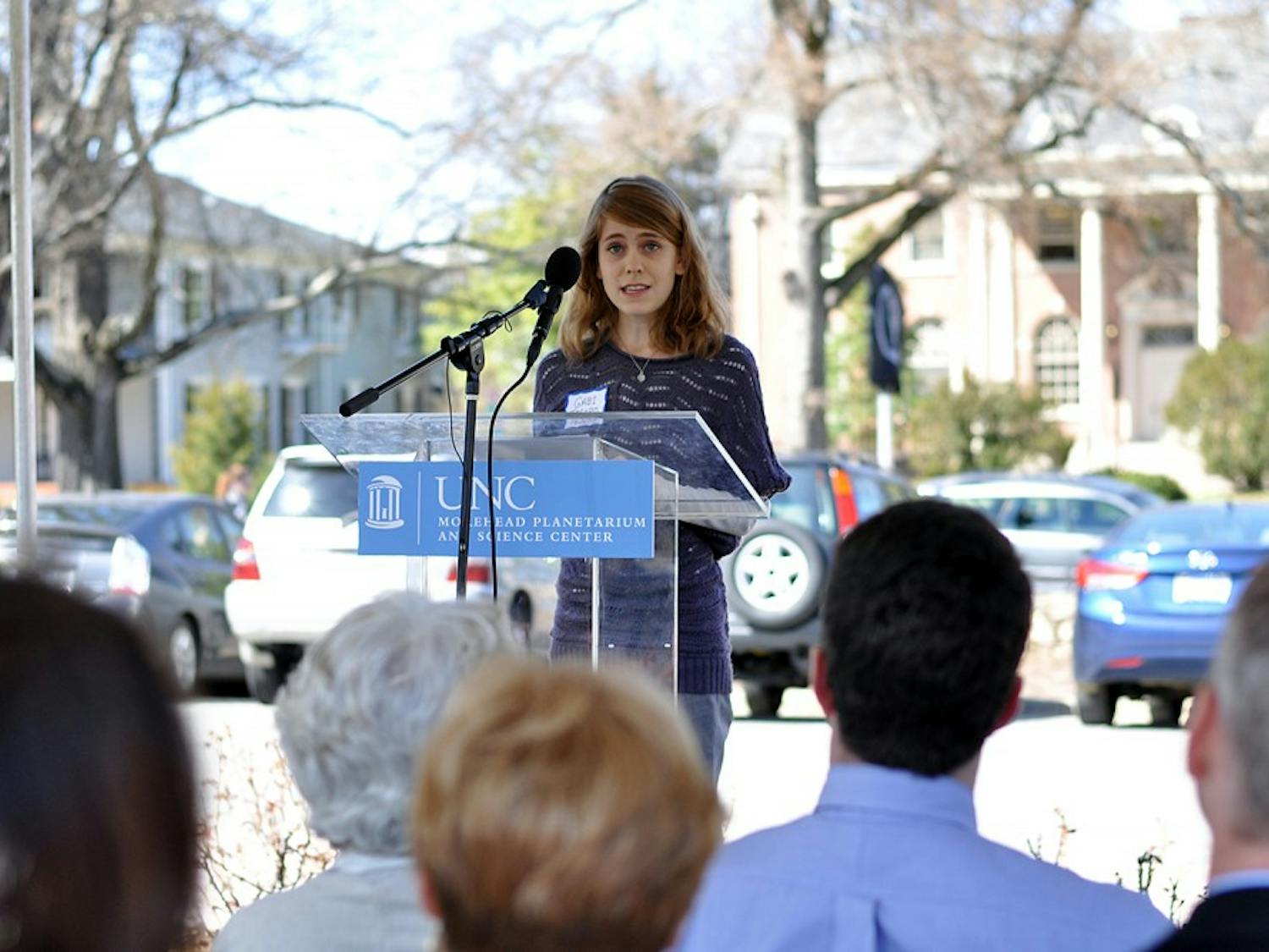 Gabi Tesoro, 16, spoke on behalf of her grandfather Richard Knapp, former astronaut educator at the Morehead Planetarium, at the NC Highway Historical Marker Dedication Ceremony outside the Morehead Planetarium and Science Center on Wednesday. 