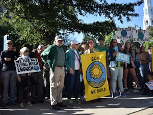 Participants of the Chapel Hill climate strike stand in the Peace and Justice Plaza in Chapel Hill on Friday, Sept. 20, 2019 to demand that the Chapel Hill Town Council calls for a national Green New Deal.&nbsp;