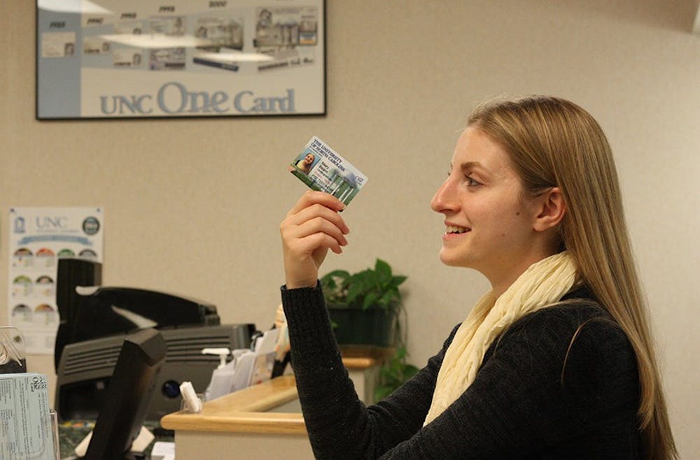 Mary Katherine Beam, a junior psychology major from Asheboro gets a new OneCard at the UNC One Card office on Monday afternoon.