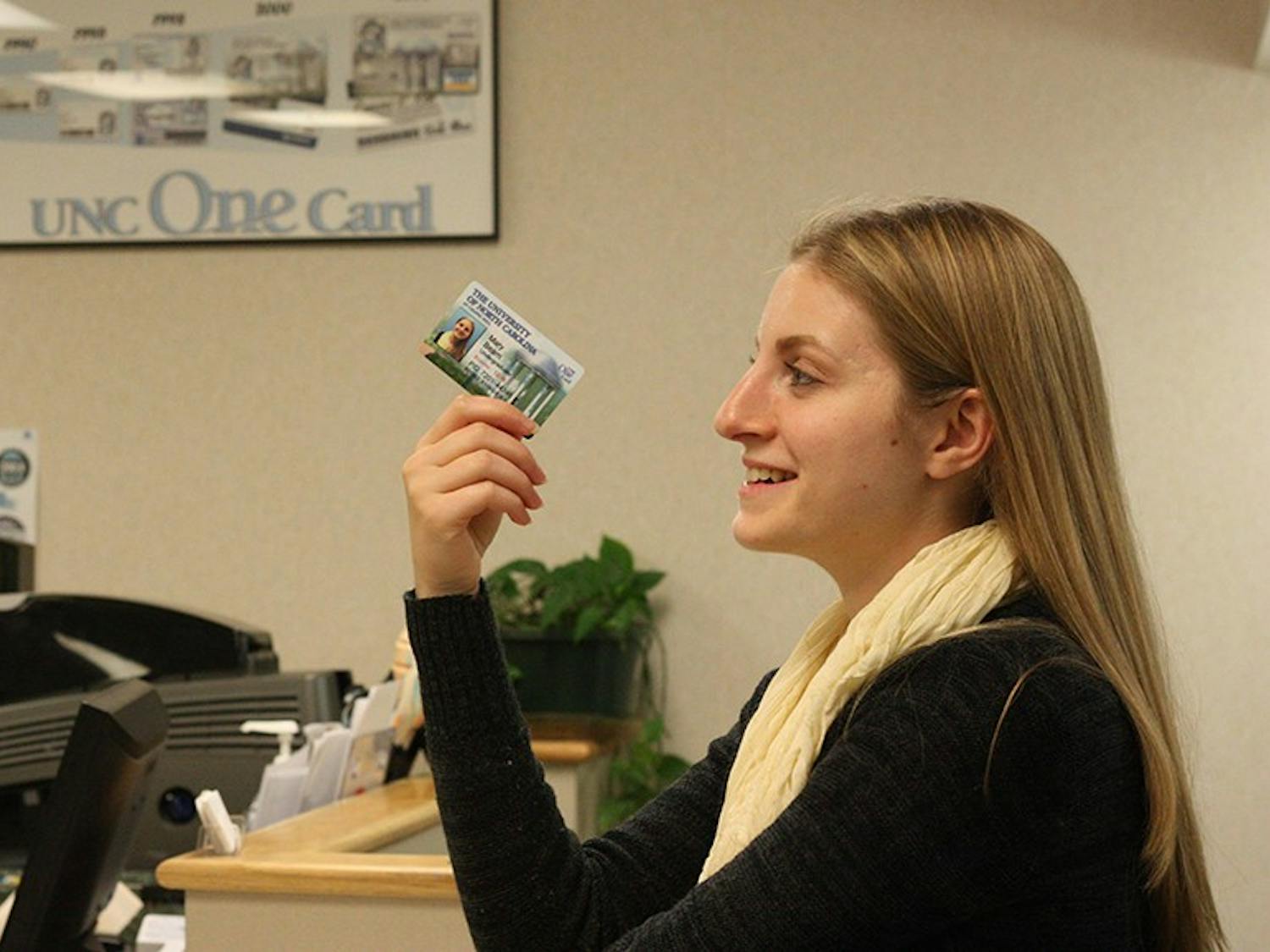 Mary Katherine Beam, a junior psychology major from Asheboro gets a new OneCard at the UNC One Card office on Monday afternoon.