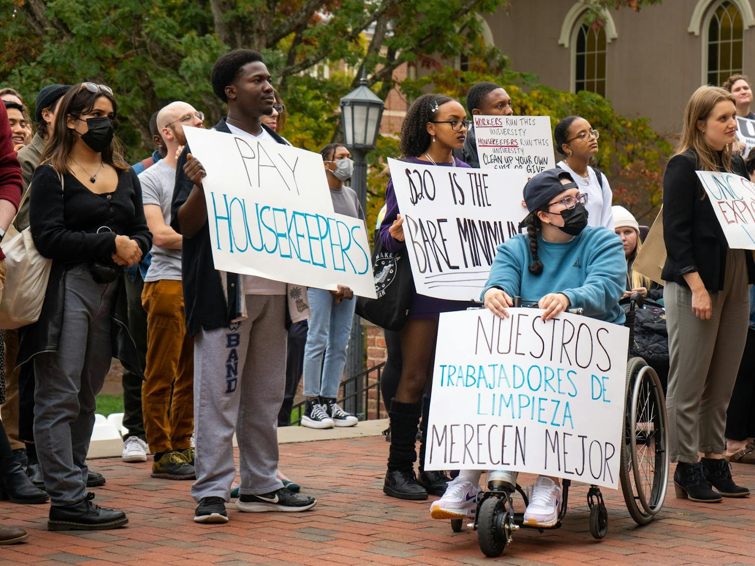 UNC students hold placards in support of the UNC Houseekepers March & Rally at the Old Well on Oct. 28, 2022.