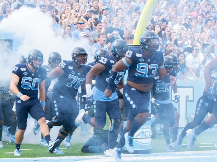 The UNC football team runs out of the tunnel before the game against Duke on Oct. 26, 2019. UNC went on to beat Duke 20-17.