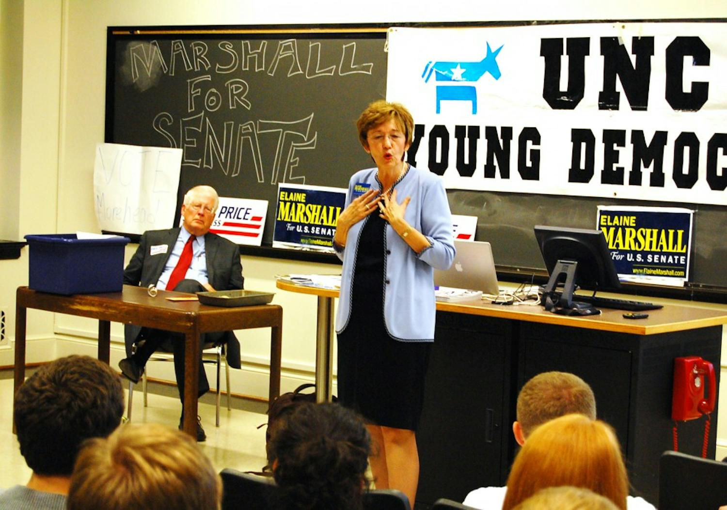 Democratic Senate candidate Elaine Marshall speaks to UNC Young Democrats in a rally held in Gardner on Wednesday. U.S. Rep. David Price, who spoke earlier in the evening, listens on as Marshall outlines her campaign and critical issues for the upcoming election.