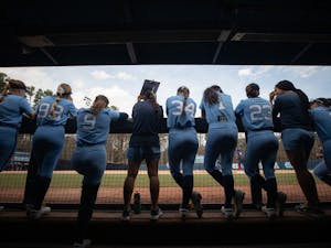 Members of the UNC softball team watch as the home game against the University of Connecticut continues on Sunday, March 6, 2022.