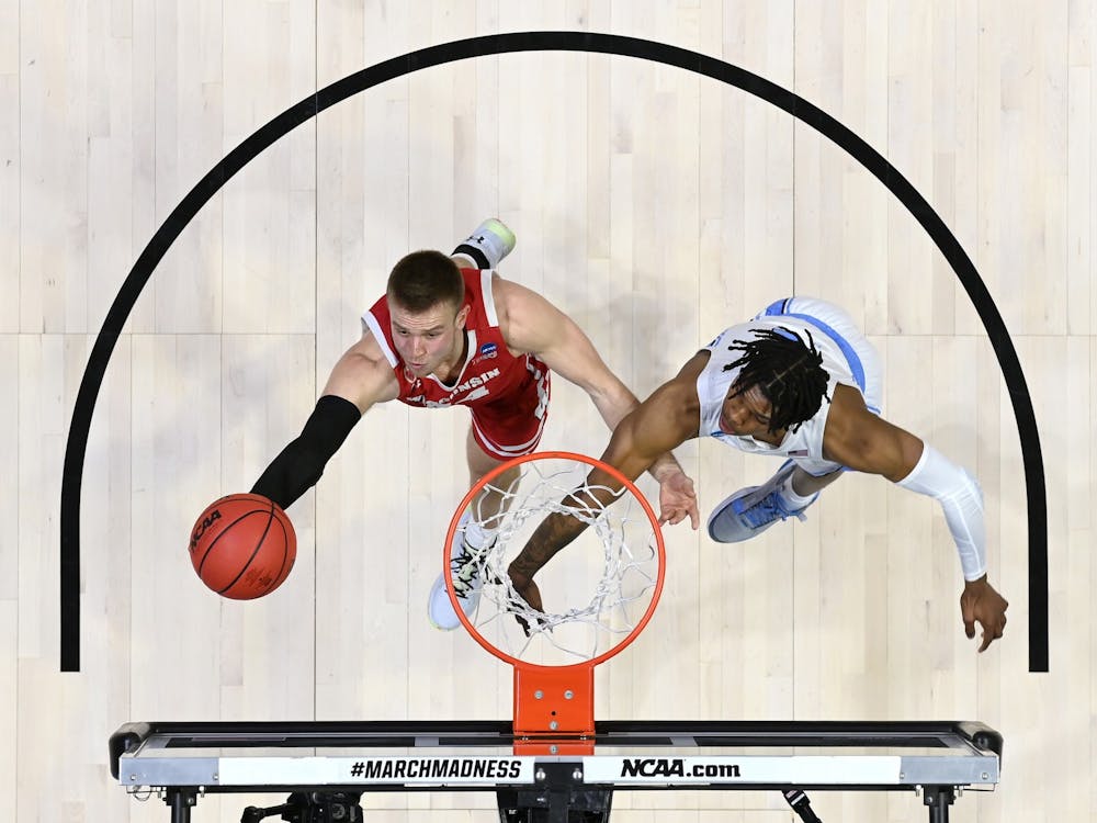 WEST LAFAYETTE, IN - MARCH 19: Brad Davison of Wisconsin works to get a shot past Caleb Love of North Carolina in the first round of the 2021 NCAA Division I Men’s Basketball Tournament held at Mackey Arena on March 19, 2021 in West Lafayette, Indiana. Photo by Andy Hancock/NCAA Photos/NCAA Photos via Getty Images