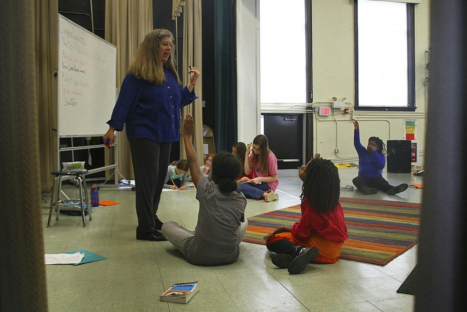 Jenny Justice, the artistic director of Hamlet Project in Durham, does vocal exercises with students in the E.K. Powe Elementary School  auditorium. 