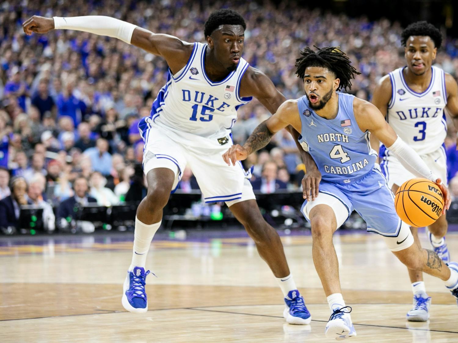 UNC sophomore guard RJ Davis (4) prepares to go up for a layup as Duke sophmore center Mark Williams (15) defends the goal during the Final Four of the NCAA Tournament against Duke in New Orleans on Saturday, April 2, 2022. UNC won 81-77.