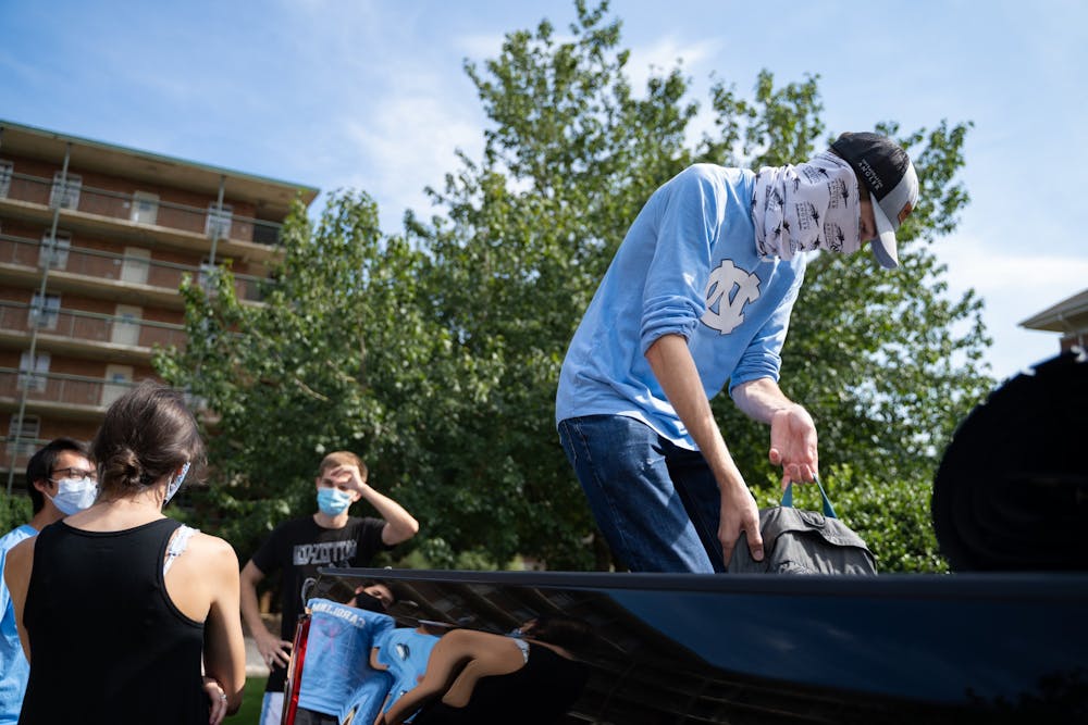<p>A first-year previously living in Craige Residence Hall moves out with the help of his suitemates on Tuesday, Aug. 18, 2020 following UNC’s announcement that all classes will be moving to an online format.</p>