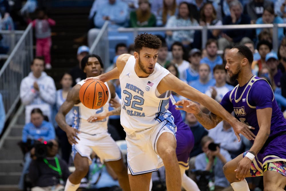 UNC graduate forward Peter Nance (32) drives toward the basket during the men's basketball game on Sunday, Nov. 20, 2022, at the Dean Smith Center. UNC beat JMU 80-64.