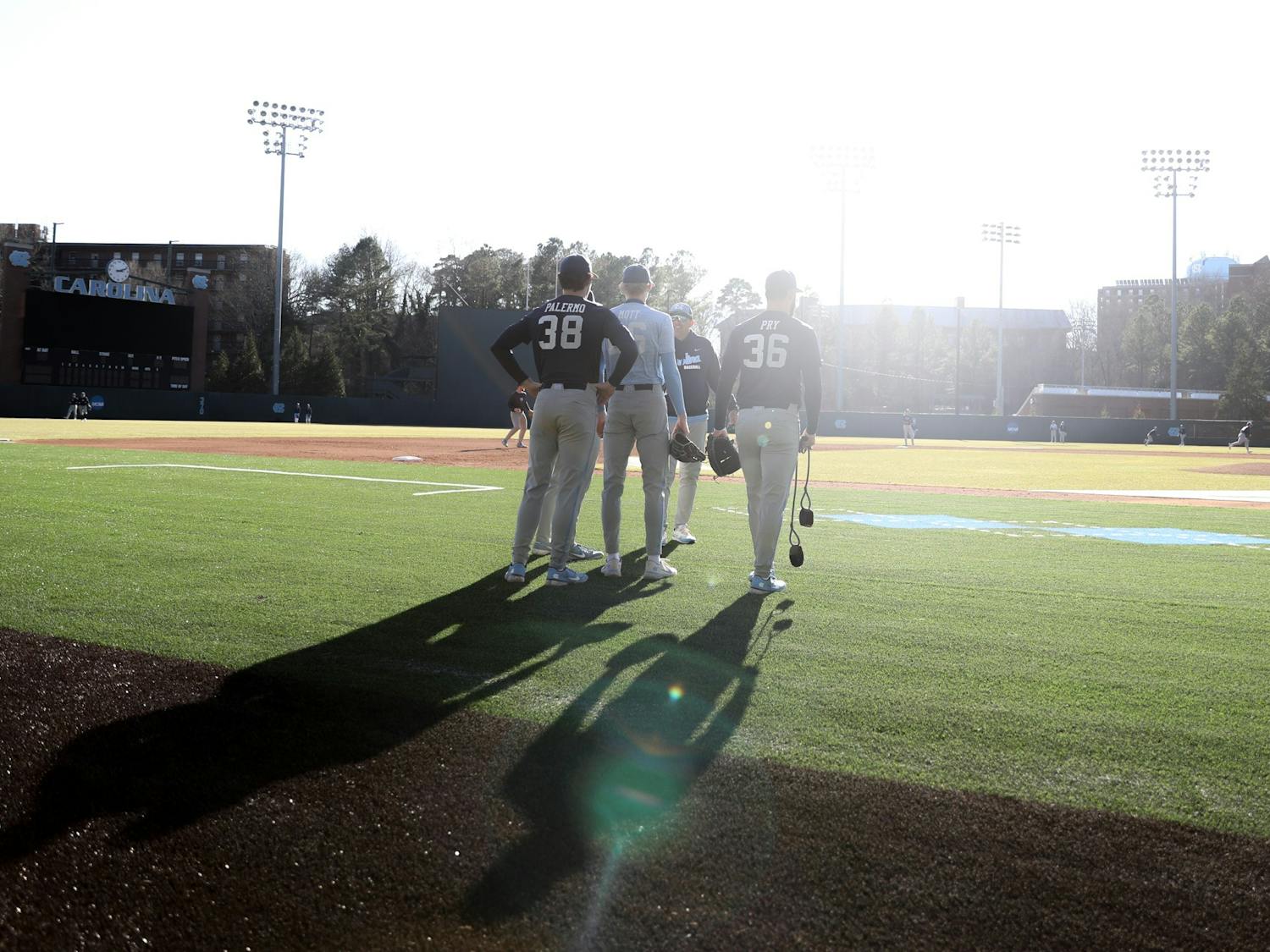 Several members of the UNC baseball team speak to Head Coach Scott Forbes during a practice on Wednesday, Jan. 26, 2022.