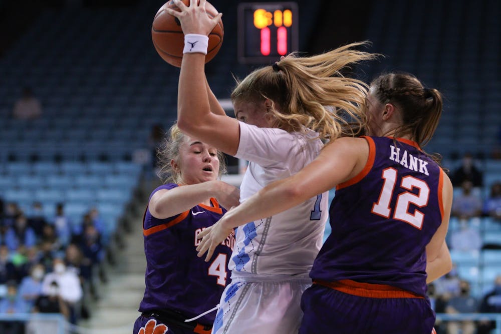 Sophomore guard Alyssa Ustby (1) blocks two Clemson defenders as she looks for an open pass. Heels are winning 46-24 against Clemson on Jan. 2, 2022.