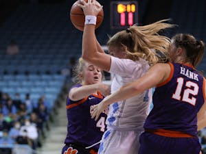 Sophomore guard Alyssa Ustby (1) blocks two Clemson defenders as she looks for an open pass. Heels are winning 46-24 against Clemson on Jan. 2, 2022.