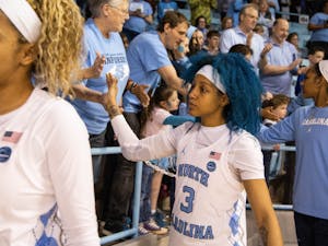UNC redshirt senior Madinah Muhammed (3) high-fives fans after the game against Duke University in Carmichael Arena on Sunday, March 1, 2020. The Blue Devils beat the Tar Heels 73-54.