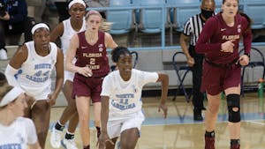 UNC redshirt sophomore guard Ariel Young (11) dribbles the ball up-court  off a fast break against Florida State on Thursday, Feb. 4, 2021. UNC fell to Florida State 61-51.