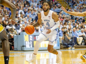 UNC sophomore guard RJ Davis (4) dribbles into the paint during UNC basketball's home game against Michigan on Wednesday, Dec. 1, 2021. UNC won 72-51.