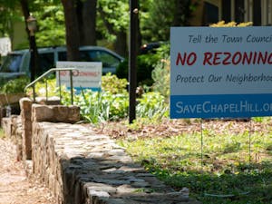 Signs protesting against the Chapel Hill Town Council’s amendment to the Town's Land Use Management Ordinance efforts, like this one in front of a home on Hillsborough Street on Tuesday, April 18, 2023, have become a recent staple on many lawns in Chapel Hill.